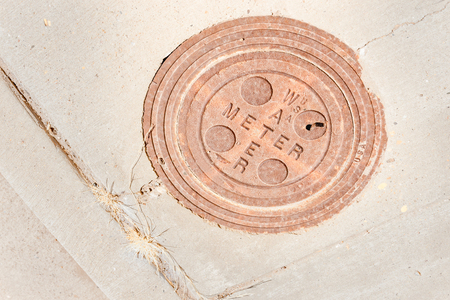 circular water meter cover in pavement