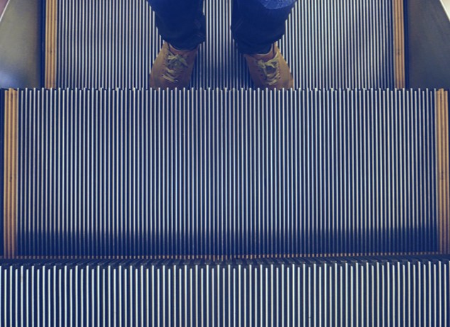 Person standing on an escalator